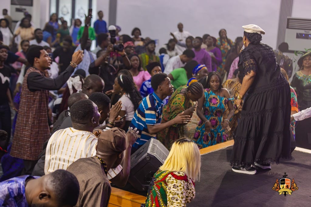 Minister Lilian Nneji ministering to a standing congregation