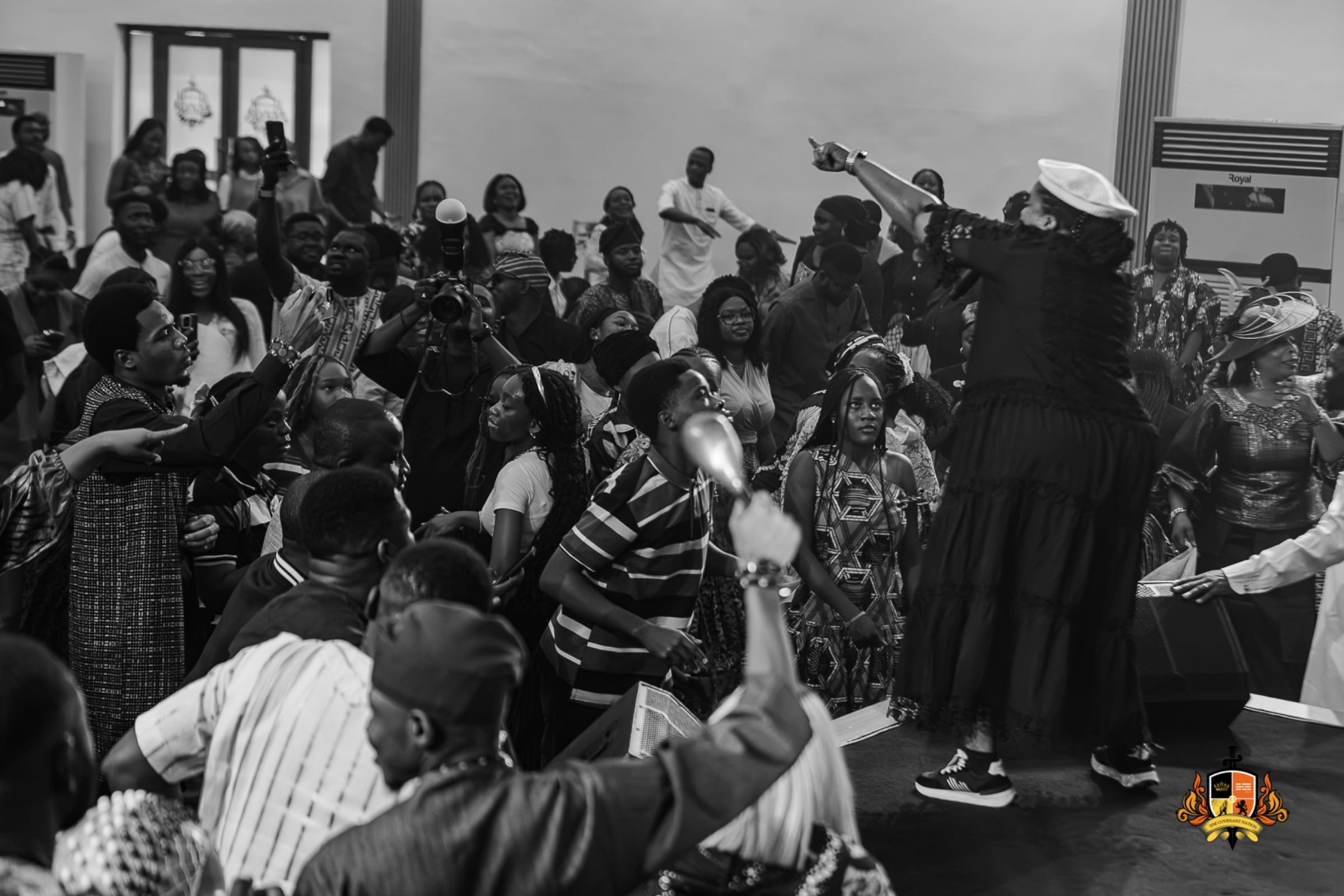Minister Lilian Nneji lifting a congregation in worship